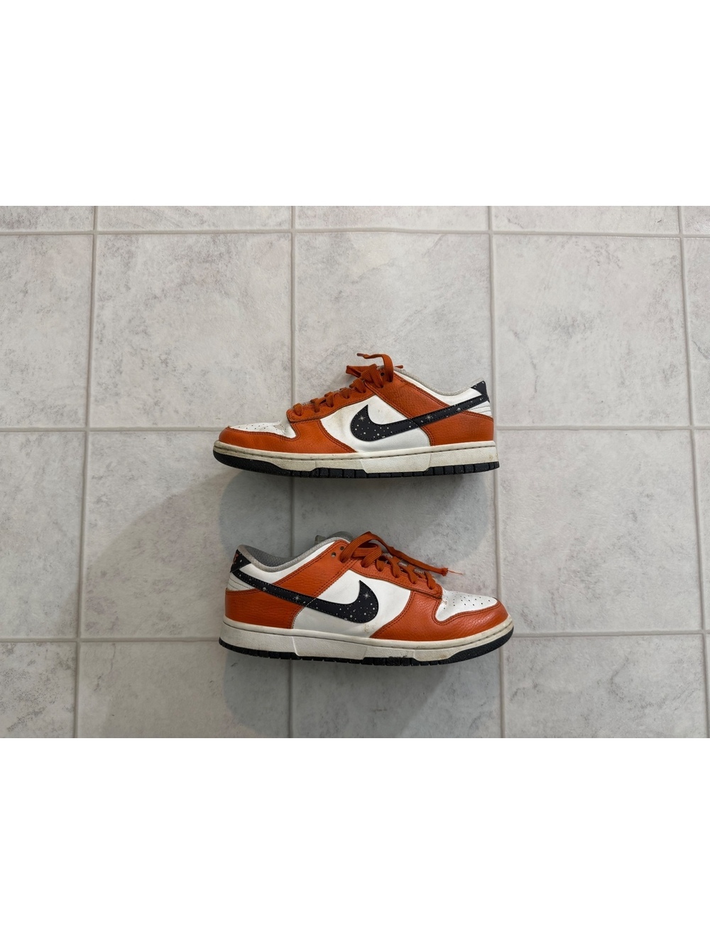 Nike orange and white low top sneakers